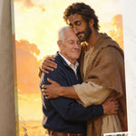 Personalized Christian canvas of an older man embraced by Jesus of Nazareth, His head resting against the man’s in warm golden light, with a small print of his original photo